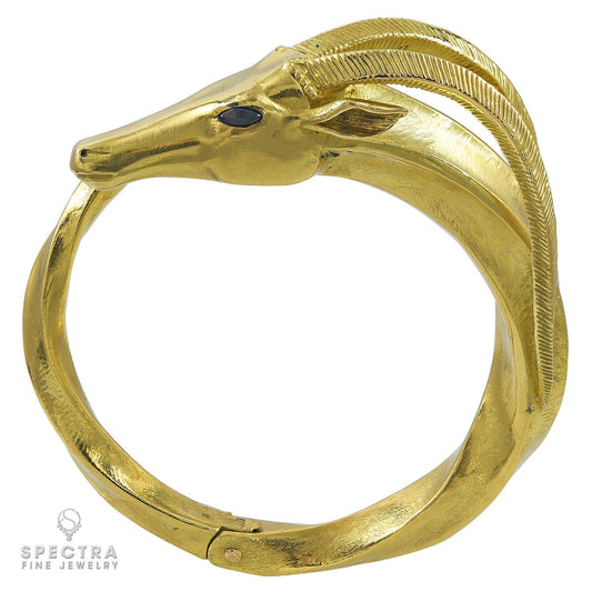 Hermès Vintage 18K Gold Capricorn Bangle with Sapphire Eyes